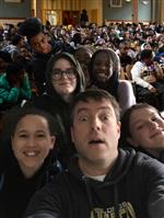 Mr. Miller with students in the auditorium  